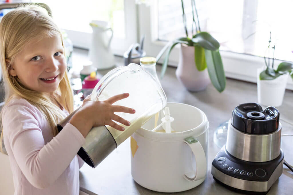 kleines Mädchen befüllt Eismaschine