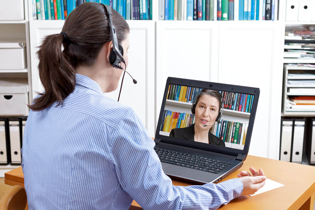 Frau mit Headset beim Online Meeting