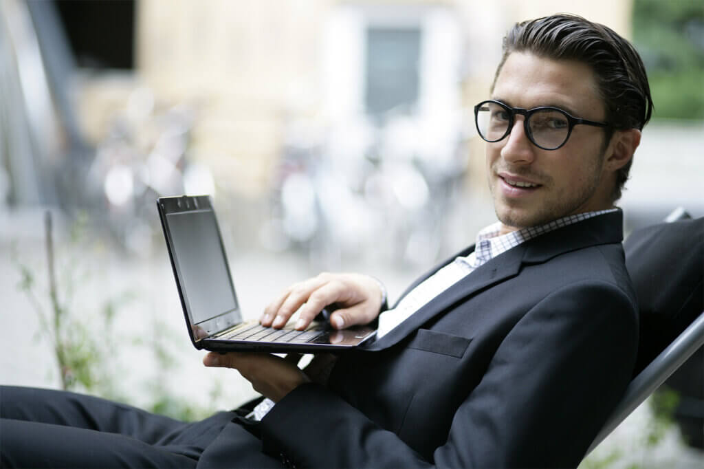 Business Mann im Liegestuhl mit Netbook